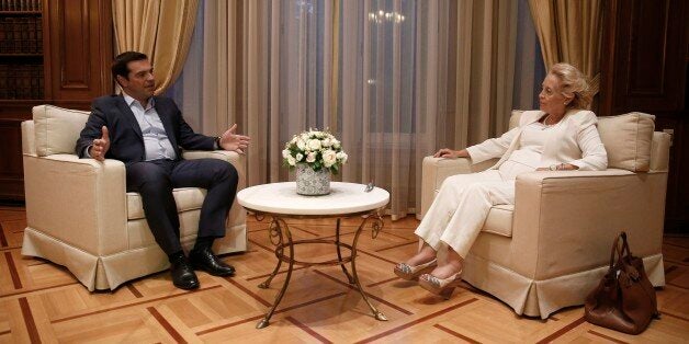 Outgoing Prime Minister Alexis Tsipras, left, speaks with Greece's new Prime Minister Vassiliki Thanou, during a handover ceremony in Athens, Thursday, Aug. 27, 2015. Greece came one step closer on Thursday to early elections with President Prokopis Pavlopoulos appointing the head of the country's Supreme Court Vassiliki Thanou as caretaker prime minister to lead the country to next month's polls. (AP Photo/Petros Giannakouris)