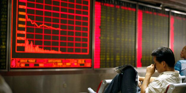 A Chinese investor monitors stock prices at at a brokerage house in Beijing, Monday, Aug. 24, 2015. Stocks tumbled across Asia on Monday as investors shaken by the sell-off last week on Wall Street unloaded shares in practically every sector. (AP Photo/Mark Schiefelbein)