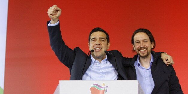 OMONIA SQUARE, ATHENS, ATTICA, GREECE - 2015/01/22: Alexis Tsipras (left), the leader of SYRIZA and the most promising candidate to be the next Prime Minister of Greece, embraces Pablo Iglesias TurriÃ³n (right), the leader of the Spanish Podemos party, giving a clenched fist salute. SYRIZA (Coalition of the Radical Left), the leading party in the opinion polls, held their final election rally in Athens. (Photo by Michael Debets/Pacific Press/LightRocket via Getty Images)