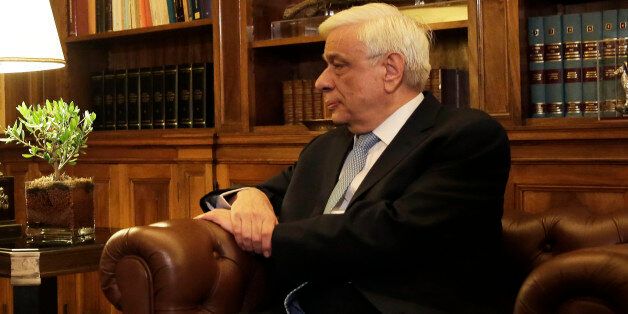 Greek Prime Minister Alexis Tsipras , left, speaks with Greek President Prokopis Pavlopoulos, during their meeting in Athens, Thursday, Aug. 20, 2015. Tsipras announced his governmentâs resignation and called early elections Thursday, seeking to consolidate his mandate to implement a new three-year international bailout that sparked a rebellion within his radical left Syriza party. (AP Photo/Petros Giannakouris)