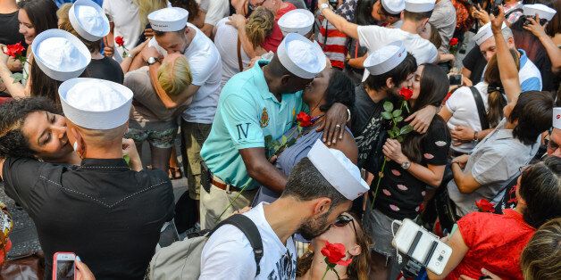 TIMES SQUARE, NEW YORK, UNITED STATES - 2015/08/14: Couples kiss, imitating the sailor and nurse in Eisenstaedt's photograph. To mark the 70th anniversary of the surrender of the Japanese ending WWII, the Times Square Alliance and 'Spirit of '45,' a WWII legacy organization, hosted a kiss-in with members of the public invited to imitate the sailor and nurse in Alfred Eisenstaedt's famous photograph. (Photo by Albin Lohr-Jones/Pacific Press/LightRocket via Getty Images)
