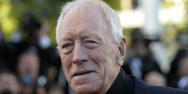 Swedish actor Max von Sydow poses on May 24, 2013 as he arrives for the screening of the film 'The Immigrant' presented in Competition at the 66th edition of the Cannes Film Festival in Cannes. Cannes, one of the world's top film festivals, opened on May 15 and will climax on May 26 with awards selected by a jury headed this year by Hollywood legend Steven Spielberg. AFP PHOTO / ANNE-CHRISTINE POUJOULAT (Photo credit should read ANNE-CHRISTINE POUJOULAT/AFP/Getty Images)