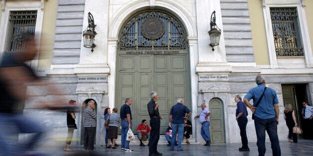 Pensioners queue to enter a National Bank of Greece SA bank branch to collect their pension payments in Athens, Greece, on Friday, July 17, 2015. Germany's Parliament is set to ratify bridge financing and the start of talks for a three-year rescue plan. Photographer: Matthew Lloyd/Bloomberg via Getty Images