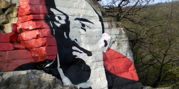 ** FILE ** In this 2008 file photo a large painting of Vladimir Lenin seen on the Mashuk Mountain on the outskirts of Pyatigorsk, southern Russia. Police say vandals have sprayed paint and drawn a swastika across a large painting of Vladimir Lenin on a mountainside in Pyatigorsk. The portrait on the Mashuk Mountain in Pyatigorsk was created in 1925 and had periodically been given a fresh coat of paint. The area has come to be known as Lenin Rocks, and a spa at the bottom of the mountain also carries the name. (AP Photo)