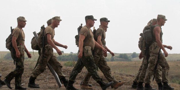 Ukrainian soldiers march during a training exercise under the supervision of British instructors on the military base outside Zhitomir, Ukraine, Tuesday, Aug. 11, 2015. Britain's defense secretary says his nation is doubling the number of Ukrainian troops it will train this year in an effort to support Kiev in its fight against Russia-backed separatists.(AP Photo/Efrem lukatsky)