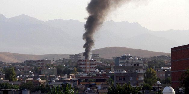 Smoke billows from a fire during firefight between the police and Kurdistan Workers' Party, or PKK militants in the town of Silopi, southeastern Turkey, Friday, July 7, 2015. Police clashed with supporters of a Kurdish rebel group in southeastern Turkey on Friday in a four-hour gunfight that killed three people, Turkey's state-run news agency reported. Violence has flared between the autonomy-seeking PKK, and Turkey's security forces in the past two weeks, wrecking an already fragile peace process between the government and the rebels. (Mehmet Selim Yalcin/Dogan News Agency via AP) TURKEY OUT