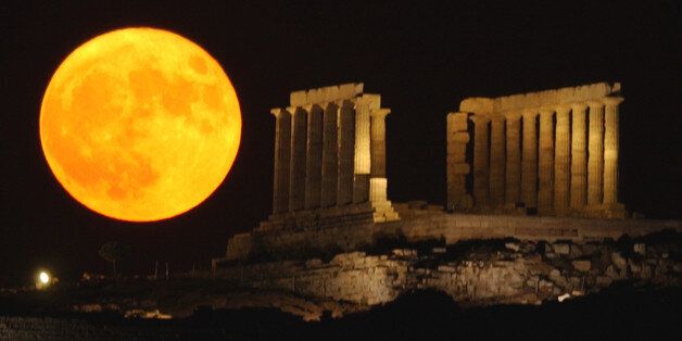 The full moon rises behind the ancient temple of Posseidon, in Sounio about 73 kilometers (45 miles) south-east of Athens, on Thursday, July 21, 2005. Tonight's full moon appear bigger than usual, as the distance between the Earth and its only natural satellite was the closest until 2007, at about 357290 km (223306 miles). (AP Photo/Petros Giannakouris)
