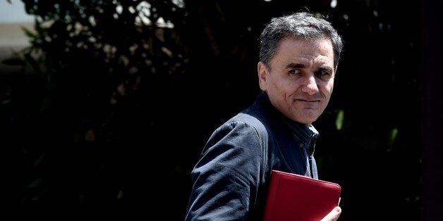 (FILES) In this file picture taken on June 15, 2015 Greek minister of International Economic Relations Euclidis Tsakalotos arrives for a meeting at the Prime minister's office in Athens. Greece on July 6, 2015 named economist Euclid Tsakalotos, its top negotiator in the stalled EU-IMF talks, as the country's new finance minister, the president's office said. AFP PHOTO / ARIS MESSINIS (Photo credit should read ARIS MESSINIS/AFP/Getty Images)