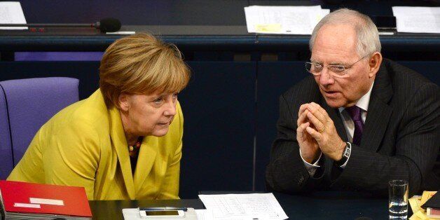 German Chancellor Angela Merkel (L) and German Finance Minister Wolfgang Schaeuble (R) chat during a session of the Lower house of parliament Bundestag on November 28, 2014 at the Reichstag building in Berlin before a vote to approve the budget blueprint for 2015. AFP PHOTO / JOHN MACDOUGALL (Photo credit should read JOHN MACDOUGALL/AFP/Getty Images)