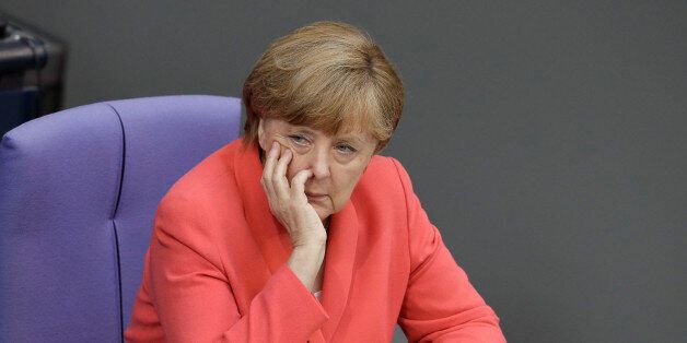 German Chancellor Angela Merkel attends a meeting of the German federal parliament, Bundestag, in Berlin, Germany, Friday, July 17, 2015. Merkel is asking German lawmakers to clear the way for negotiations on a new, third bailout package for Greece, arguing that it would be negligent not to try for a deal. (AP Photo/Michael Sohn)