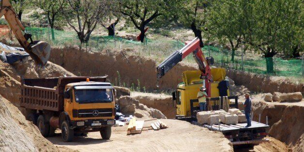 A photo taken on August 19, 2014 shows a crane putting aside the marbles of the entry of the site where archaeologists have unearthed a funeral mound dating from the time of Alexander the Great, in Amphipolis, Northern Greece. It is believed to be the largest ever discovered in Greece but archaeologists are stumped about who was buried in it. AFP PHOTO /SAKIS MITROLIDIS (Photo credit should read SAKIS MITROLIDIS/AFP/Getty Images)