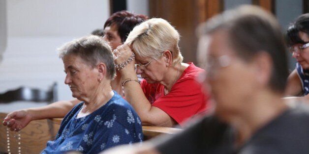 Inhabitants prays in local church in Vrpolje on August 12, 2015, after hearing in the news that Islamic State group claims to have beheaded Croatian hostage Tomislav Salopek, 31 years old, working for French geoscience company CGG and abducted last month west of Cairo. Prime Croatian Minister Zoran Milanovic said on August 12 he was unable to confirm the death of a hostage that the Islamic State group claimed to have beheaded, but that he feared the worst. TThe Islamic State group posted a purpo