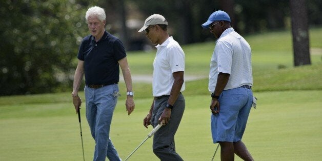 Former US President Bill Clinton (L), US President Barack Obama (C) and Ron Kirk golf at Farm Neck Golf Club August 15, 2015 in Oak Bluffs, Massachusetts on Martha's Vineyard. Obama golfed with former US President Clinton, Vernon Jordan and Ron Kirk. AFP PHOTO/BRENDAN SMIALOWSKI (Photo credit should read BRENDAN SMIALOWSKI/AFP/Getty Images)