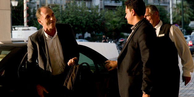 Greece's Economy Minister Giorgos Stathakis, left, arrives at a hotel to continue talks with bailout negotiators, in central Athens, on Monday, Aug. 10, 2015. Athens and the negotiators are hoping to conclude talks Tuesday for a third bailout package. (AP Photo/Petros Giannakouris)