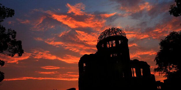The Atomic Bomb Dome is silhouetted at sunset in Hiroshima, western Japan, Monday, Aug. 5, 2013. Hiroshima marks the 68th anniversary of the world's first atomic bombing Tuesday.(AP Photo/Shizuo Kambayashi)