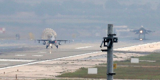 Turkish Air Force fighter planes land at Incirlik Air Base, on the outskirts of the city of Adana, southern Turkey, Thursday, July 30, 2015. After months of reluctance, Turkish warplanes last week started striking militant targets in Syria and agreed to allow the U.S. to launch its own strikes from Turkey's strategically located Incirlik Air Base. In a series of cross-border strikes, Turkey has not only targeted the IS group but also Kurdish fighters affiliated with forces battling IS in Syria and northern Iraq and Kurdistan Workers' Party, or PKK positions within Turkey. (AP Photo/Emrah Gurel)