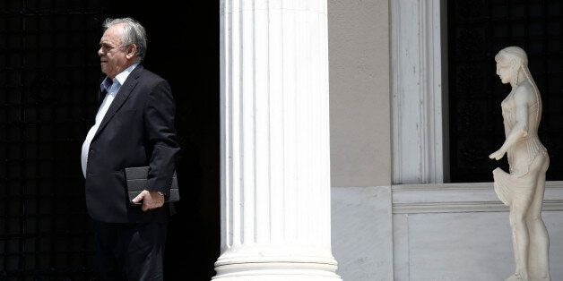 Yannis Dragasakis, Greece's deputy prime minister, leaves Maximos Mansion following a meeting with Alexis Tsipras, Greece's prime minister, in Athens, Greece, on Sunday, June 28, 2015. Greek bank executives and European officials are warning of an imminent cash crunch or bank shutdown after talks on a new aid package collapsed. Photographer: Kostas Tsironis/Bloomberg via Getty Images