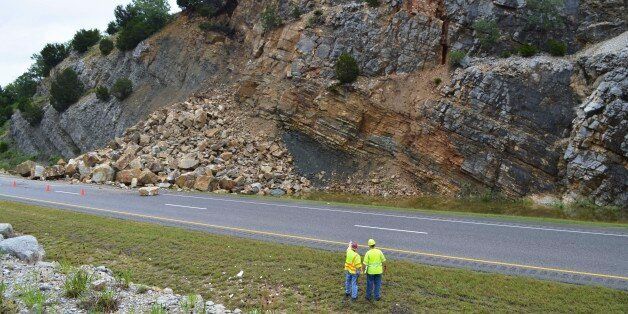 In this undated photo provided by the Oklahoma Department of Transportation, a crack in rocks above and a rock slide onto Interstate 35 north is pictured. The Oklahoma Department of Transportation voted unanimously on Tuesday, June 30, 2015, to authorize five separate contracts, including $1.3 million to stabilize a rock slide in the Arbuckle Mountains that has shut down the northbound lanes of Interstate 35. That contract will include about $870,000 to secure the rock face and $430,000 to dispose of the rock that slid onto the shoulder after the heavy May storms.(Oklahoma Department of Transportation Photo via AP)