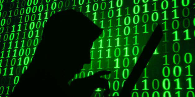 Computer hacker silhouette. Green binary code background