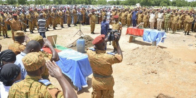 People attend on August 24, 2014 in Ouagadougou the funeral of two United Nations peacekeepers from Burkina Faso who were killed in a suicide car bombing at the MINUSMA (United Nations peacekeeping mission in Mali) camp in Ber, northern Mali on August 16, 2014. AFP PHOTO / AHMED OUOBA (Photo credit should read AHMED OUOBA/AFP/Getty Images)