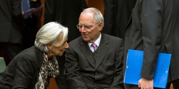 Christine Lagarde, managing director of the International Monetary Fund, left, and Wolfgang Schaeuble, Germany's finance minister, speak ahead of the eurogroup meeting in Brussels, Belgium, on Sunday, March 24, 2013. Cyprus's fate hangs in the balance as euro-area finance ministers meet today to decide whether the tiny Mediterranean island has done enough for a bailout that will avert its financial collapse. Photographer: Jock Fistick/Bloomberg via Getty Images
