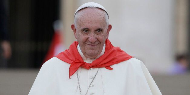 Pope Francis wears a red scarf as he leaves St. Peter's Square at the Vatican after an audience with Altar boys and girls Tuesday, Aug. 4, 2015. (AP Photo/Gregorio Borgia)