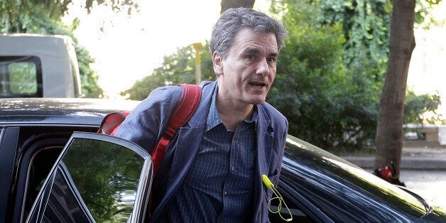 Greece's Finance Minister Euclid Tsakalotos arrives for a meeting at Syriza governing party headquarters in Athens, Tuesday, July 14, 2015. With members of his own party openly denouncing a preliminary rescue deal struck with Greece's European creditors, Prime Minister Alexis Tsipras must fight to cling to his government's majority after he was forced to shred election promises and introduce punishing austerity measures in exchange for the bailout. (AP Photo/Thanassis Stavrakis)