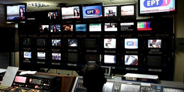 Employees of Greek state broadcaster ERT work inside the control room, during the news broadcast of the station in Athens on June 11, 2015. Greece's public broadcaster ERT came back on the air on Thursday, exactly two years after it was shut down by the previous government, which accused it of being wasteful and mismanaged. AFP PHOTO / ANGELOS TZORTZINIS (Photo credit should read ANGELOS TZORTZINIS/AFP/Getty Images)