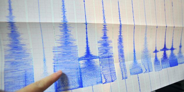 A man points at a seismic chart at the Central Weather Bureau in Taipei on March 4, 2010 after a 6.4 magnitude rocked southern Taiwan near the island's second largest city of Kaohsiung. The quake hit about 70 kilometres (about 40 miles) from the main southern city of Kaohsiung, the US Geological Survey said, and it was felt as far away as the capital Taipei in the north of the island. AFP PHOTO / Sam YEH (Photo credit should read SAM YEH/AFP/Getty Images)