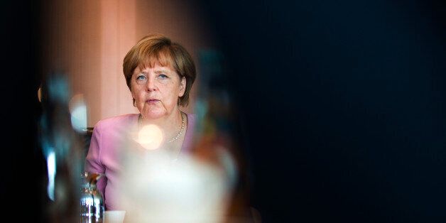 German chancellor Angela Merkel waits for the beginning of her first cabinet meeting after her summer holidays in the Chancellery in Berlin, Germany, Wednesday, Aug. 12, 2015. (AP Photo/Gero Breloer)