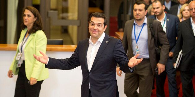 Greek Prime Minister Alexis Tsipras, center, leaves the building after an emergency summit of eurozone heads of state or government in Brussels on Tuesday, July 7, 2015. Frustrated and angered eurozone leaders gave Greek Prime Minister Alexis Tsipras a last-minute chance on Tuesday to finally come up with a viable proposal on how to save his country from financial ruin. (AP Photo/Michel Euler)