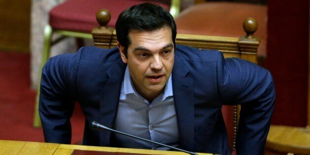 Greece's Prime Minister Alexis Tsipras arrives for an emergency parliament session in Athens, Wednesday, July 22, 2015. Greece's liquidity-starved banks got a new cash injection from the European Central Bank on Wednesday, hours before a key vote in parliament on further economic reforms demanded by international creditors in return for a third bailout. (AP Photo/Thanassis Stavrakis)