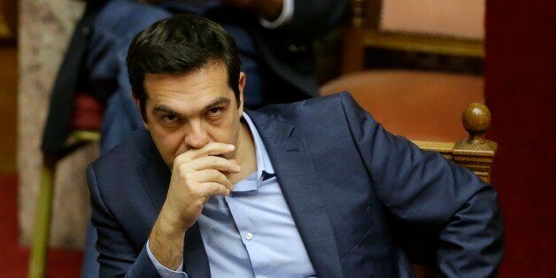 Greece's Prime Minister Alexis Tsipras attends an emergency parliament session in Athens, Wednesday, July 22, 2015. Greece's liquidity-starved banks got a new cash injection from the European Central Bank on Wednesday, hours before a key vote in parliament on further economic reforms demanded by international creditors in return for a third bailout. (AP Photo/Thanassis Stavrakis)
