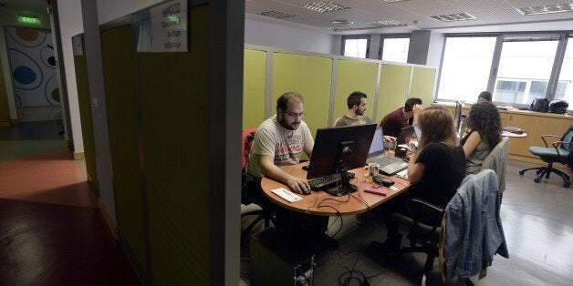 TO GO WITH AFP STORY BY SOPHIE MAKRIS -- People work in the offices of a Start-up in Athens on November 12, 2014. As the Greek economy is recovering from six years of recession and posted last week its first quarter of positive growth since 2008, a new wave of start-ups is hoping to become game changer in the Greek economy. AFP PHOTO / LOUISA GOULIAMAKI (Photo credit should read LOUISA GOULIAMAKI/AFP/Getty Images)