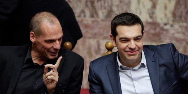 Greece's Prime Minister Alexis Tsipras, right, and Finance Minister Yanis Varoufakis chat during a Presidential vote in Athens, on Wednesday, Feb. 18, 2015. Greece's parliament elected Prokopis Pavlopoulos, a conservative law professor and veteran politician Wednesday as the country's new president, after he received support from the new left-wing government and main center-right opposition party. (AP Photo/Petros Giannakouris)