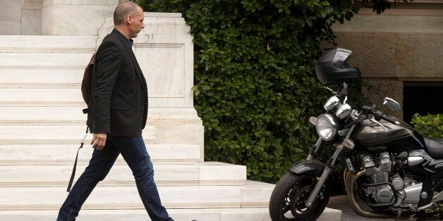 Greek Finance Minister Yanis Varoufakis walks towards his motorbike as he leaves Maximos Mansion in Athens, Sunday, June 28, 2015. Greece is anxiously awaiting a decision by the European Central Bank on whether to increase the emergency liquidity assistance banks can draw on from the country's central bank.(AP Photo/Daniel Ochoa de Olza)