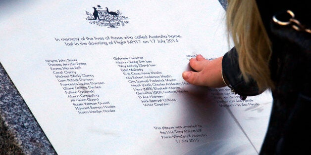 CANBERRA, AUSTRALIA - JULY 17: A relative of an Australian victim of Malaysia Airlines jet MH17 touches a memorial that was unveiled outside Parliament House on July 17, 2015 in Canberra, Australia. 298 people died when Malaysian Airlines flight MH17 was struck down by a missile over Ukraine on 17 July, 2014. (Photo by David Gray- Pool/Getty Images)