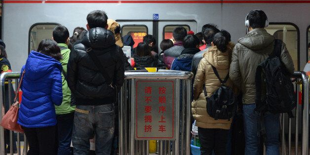 BEIJING, CHINA - DECEMBER 29: (CHINA OUT) People line up for a subway during the first weekday after the subway adpoted new fare policy at Sihui East Station on December 29, 2014 in Beijing, China. Beijing's subway has adopted new price policy on Sunday. The starting fare for subway rised to 3 RMB (about 0.48 USD) and only cover the first 6 km ride compared with the previous falt-fare 2 RMB (about 0.32 USD) for unlimited transfers. The subway fares will be charged in accordance to the distance you ride which may double the previous prices on average. (Photo by ChinaFotoPress/ChinaFotoPress via Getty Images)