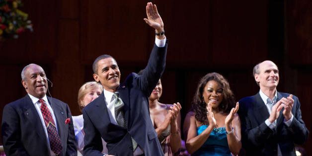 US President Barack Obama waves after leading the singing of Happy Birthday to Massachusetts Senator Ted Kennedy during a musical birthday salute to Kennedy at the Kennedy Center in Washington, DC, March 8, 2009. Standing alongside Obama are Bill Cosby (L), Denyce Graves (2nd R) and James Taylor (R). AFP PHOTO / Saul LOEB (Photo credit should read SAUL LOEB/AFP/Getty Images)