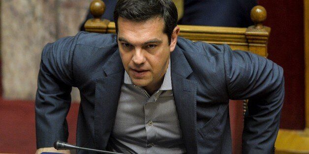 Greek Prime Minister Alexis Tsipras takes part at a joint session of four committees of the Parliament (Economic, Social, Public Administration and Production and Trade) at the Greek Parliament in Athens on July 10, 2015. Lawmakers in Greece are to vote whether to back a last-ditch reform plan the government submitted to creditors overnight in a bid to stave off financial collapse and exit from the Eurozone. Greece's international creditors believe its latest debt proposals are positive enough to be the basis for a new bailout worth 74 billion euros, an EU source said June 10. AFP PHOTO/ANDREAS SOLARO (Photo credit should read ANDREAS SOLARO/AFP/Getty Images)