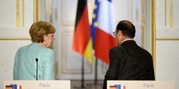 German Chancellor Angela Merkel (L) and French President Francois Hollande (R) leave following a joint press conference at the Elysee Palace on July 6, 2015, in Paris. The two leaders held a working dinner to 'evaluate the consequences of the referendum in Greece' on whether to accept tough bailout conditions, Paris said in a statement.AFP PHOTO / BERTRAND GUAY (Photo credit should read BERTRAND GUAY/AFP/Getty Images)