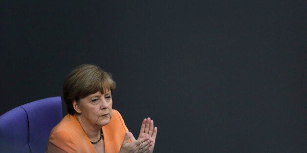 German Chancellor Angela Merkel applauds during a debate on the Greek financial crisis, at the German parliament , the Bundestag , in Berlin, Wednesday, July 1, 2015. (AP Photo/Markus Schreiber)