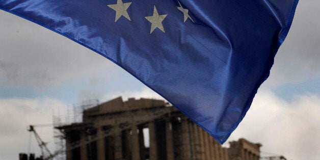 A European Union Flag flies in Athens, on Monday, Jan. 30, 2012 as the ancient Parthenon temple is seen in the background. EU leaders in Brussels Monday are expected to consider the progress of negotiations with Greece for a major debt-relief deal and second bailout loan agreement. (AP Photo/Petros Giannakouris)