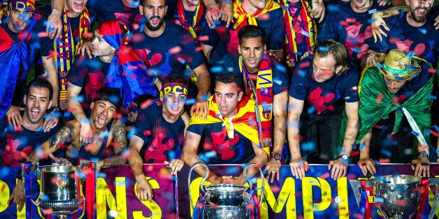 BARCELONA, SPAIN - JUNE 07: FC Barcelona players celebrate with La Liga, Copa del Rey and Champions League trophies during their victory parade after winning the UEFA Champions League Final at the Camp Nou Stadium on June 7, 2015 in Barcelona, Spain. (Photo by David Ramos/Getty Images)