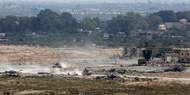 Egyptian armored vehicles patrol on the Egyptian side of the border, seen from the south of the Gaza Strip, Thursday, July 2, 2015. The Egyptian military killed 23 extremists in dawn raids Thursday in northern Sinai, security officials said, a day after Islamic militants attacked army positions in the restive peninsula and set off the bloodiest fighting in decades. The raids took place just south of the border town of Rafah, a key Sinai border town near the Gaza Strip, said the officials. (AP Photo/Adel Hana)