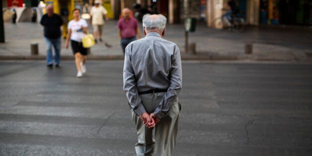 A man walks in central Athens, Monday, July 6, 2015. Greeceâs finance minister has resigned following Sundayâs referendum in which the majority of voters said ânoâ to more austerity measures in exchange for another financial bailout. (AP Photo/Emilio Morenatti)