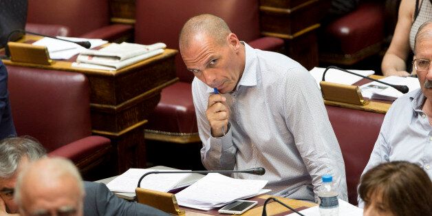 Greek former finance minister, Yanis Varoufakis , listens to the speech of Finance Minister Euclid Tsakalotos during a parliament session in Athens, Wednesday, July 15, 2015. Lawmakers on Wednesday began debating the austerity bill Greece must pass before the country can start talks on a third international bailout, amid growing anger among governing left-wing Syriza party members. (AP Photo/Petros Giannakouris)