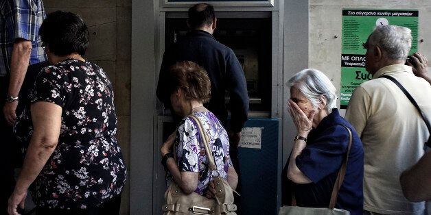 ATHENS, GREECE - JULY 2: Pensioners line up outside a National Bank branch on July 2, 2015 in Athens, Greece. As people continue to queue outside banks Greek finance minister Yanis Varoufakis said that he will quit if voters don't back him up in Sunday's referendum. (Photo by Milos Bicanski/Getty Images)