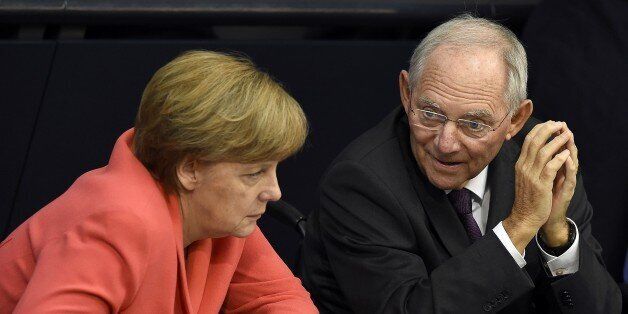 German Chancellor Angela Merkel (L) confer with finance minister Wolfgang Schaeuble during a debate in the Bundestag, the German lower house of parliament in Berlin on July 17, 2015. German lawmakers will vote during todays sitting in the Bundestag on entering into negotiations on the new aid package for Greece. AFP PHOTO / TOBIAS SCHWARZ (Photo credit should read TOBIAS SCHWARZ/AFP/Getty Images)