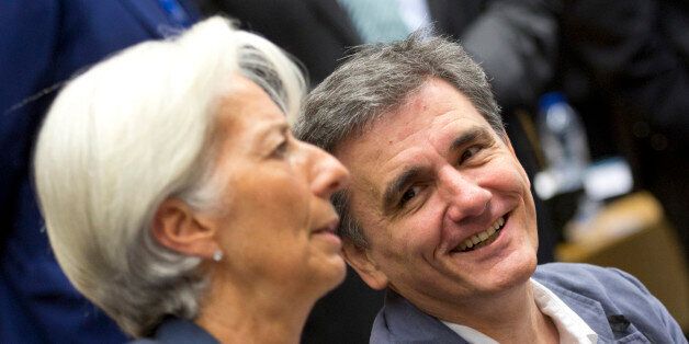Greek Finance Minister Euclid Tsakalotos, right, speaks with Managing Director of the International Monetary Fund Christine Lagarde during a round table meeting of eurogroup finance ministers at the EU Lex building in Brussels on Sunday, July 12, 2015. Greece has another chance Sunday to convince skeptical European creditors that it can be trusted to enact wide-ranging economic reforms which would safeguard its future in the common euro currency. (AP Photo/Virginia Mayo)